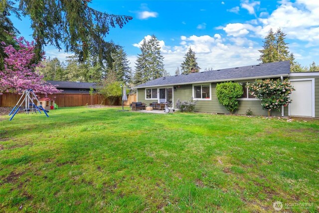 back of property with an outdoor living space, a fenced backyard, a patio area, and a yard