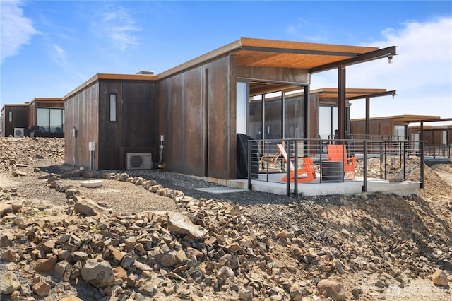 exterior space with a sunroom and ac unit