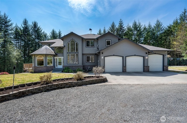 view of front facade with an attached garage, concrete driveway, and a front yard