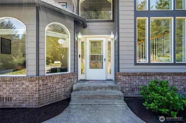 property entrance with brick siding