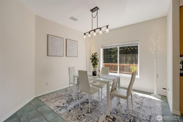 tiled dining room featuring visible vents