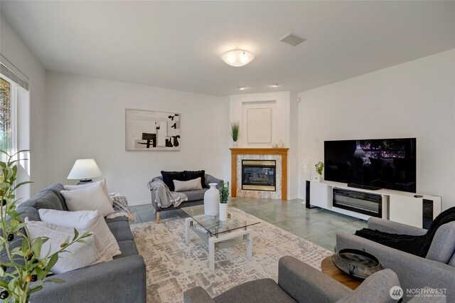 living area featuring tile patterned floors and a tiled fireplace
