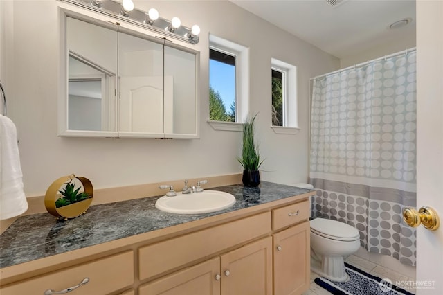 bathroom with toilet, vanity, and a shower with curtain