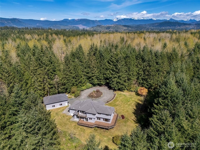 drone / aerial view with a view of trees and a mountain view