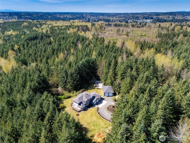 birds eye view of property featuring a wooded view