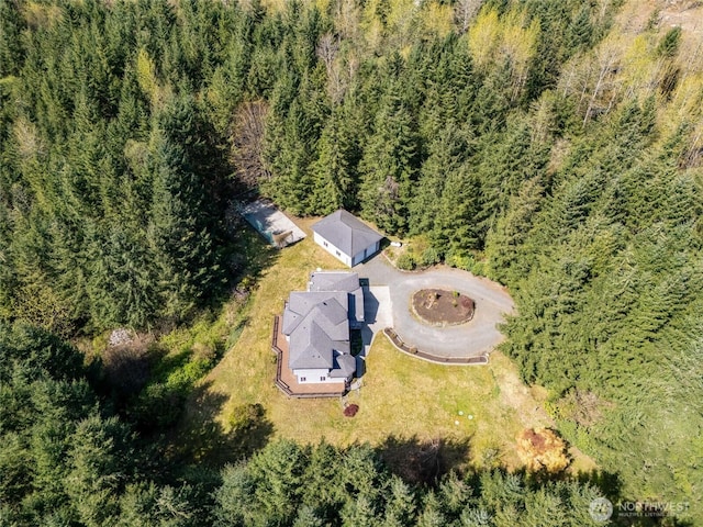 birds eye view of property with a forest view