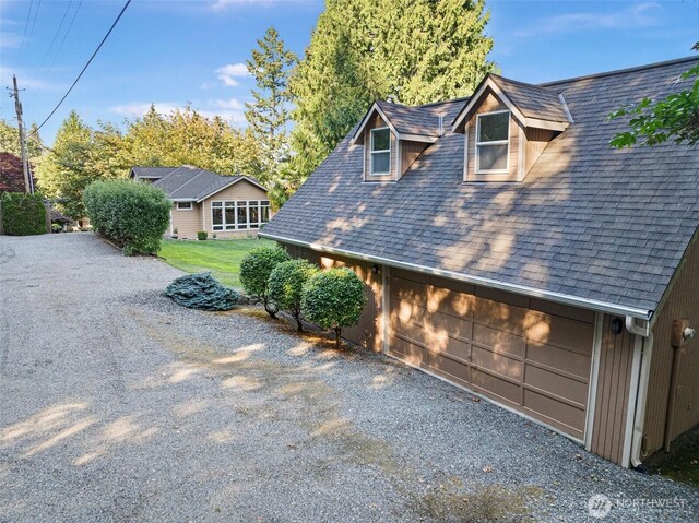 14407 Goodrich Dr NW, Gig Harbor, WA 98329 - view of home's exterior with a yard and a shingled roof