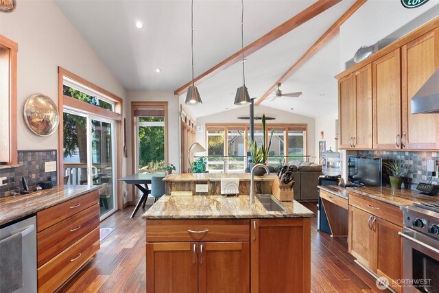 14407 Goodrich Dr NW, Gig Harbor, WA 98329 - kitchen with lofted ceiling with beams, a sink, open floor plan, appliances with stainless steel finishes, and decorative backsplash