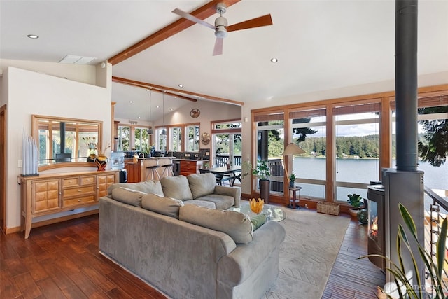 14407 Goodrich Dr NW, Gig Harbor, WA 98329 - living room featuring dark wood-style flooring, recessed lighting, a wood stove, ceiling fan, and vaulted ceiling with beams
