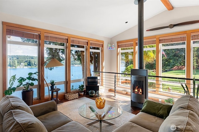 14407 Goodrich Dr NW, Gig Harbor, WA 98329 - living room featuring wood finished floors, a wood stove, and vaulted ceiling with beams