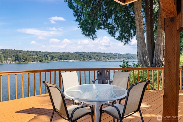 14407 Goodrich Dr NW, Gig Harbor, WA 98329 - wooden deck featuring a wooded view, a water view, and outdoor dining space