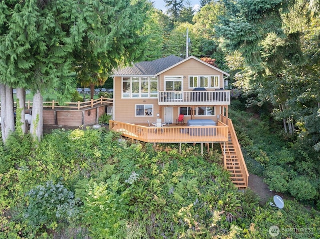 14407 Goodrich Dr NW, Gig Harbor, WA 98329 - back of property with a garden, a wooded view, a deck, and stairway