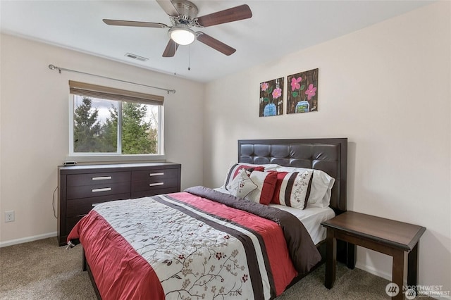 carpeted bedroom with visible vents, baseboards, and ceiling fan