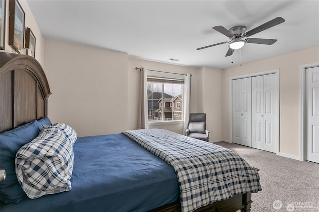 bedroom featuring baseboards, a ceiling fan, visible vents, and carpet
