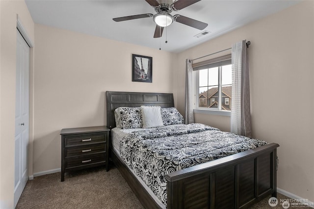 bedroom featuring dark colored carpet, baseboards, visible vents, a closet, and ceiling fan