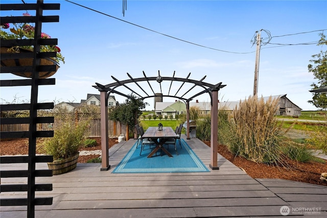 deck with outdoor dining space, fence, and a pergola
