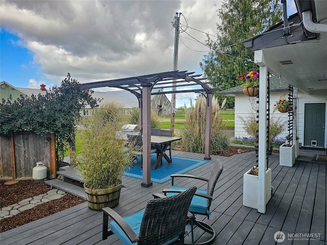 wooden terrace featuring outdoor dining space, a pergola, and fence