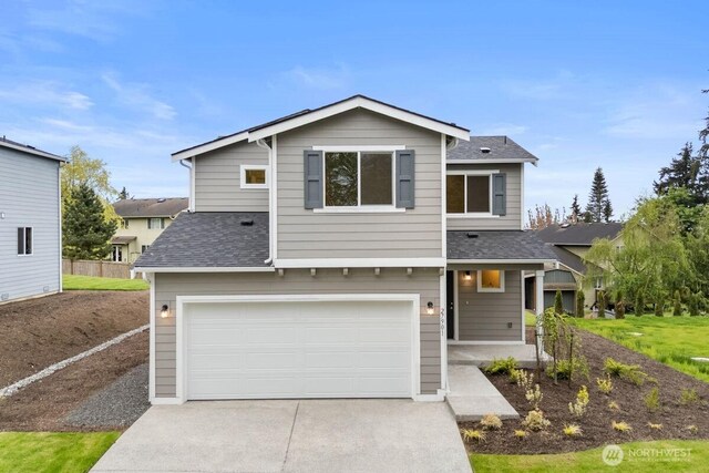 view of front facade featuring an attached garage, roof with shingles, and driveway