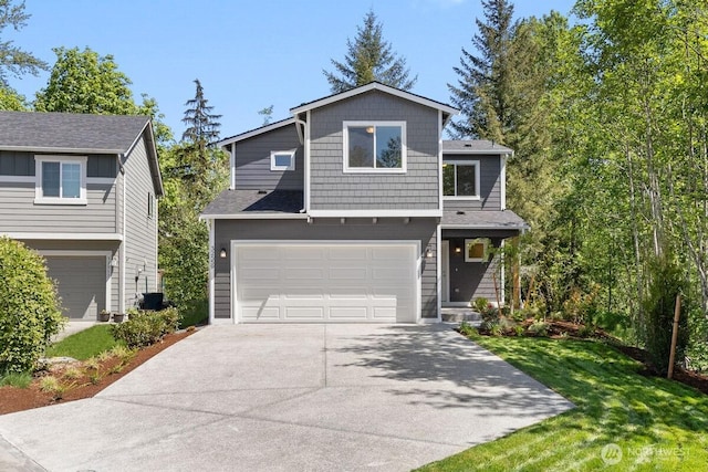 32559 141st St SE, Sultan, WA 98294 - view of front of home featuring an attached garage, driveway, and a front lawn
