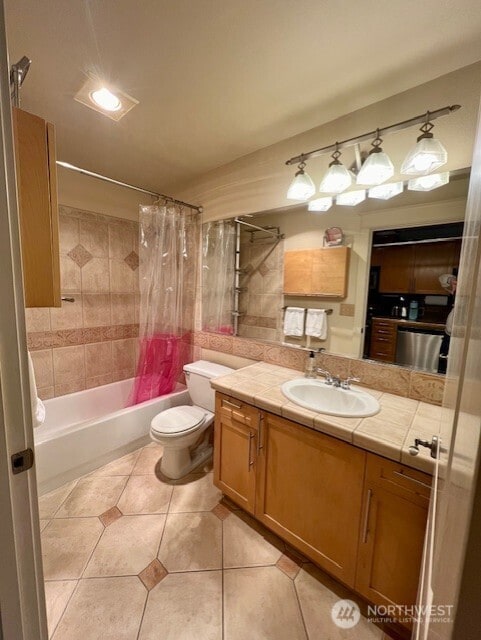 326 Queen Anne Ave N Unit 502, Seattle, WA 98109 - bathroom featuring shower / bath combination with curtain, tile patterned floors, vanity, and toilet