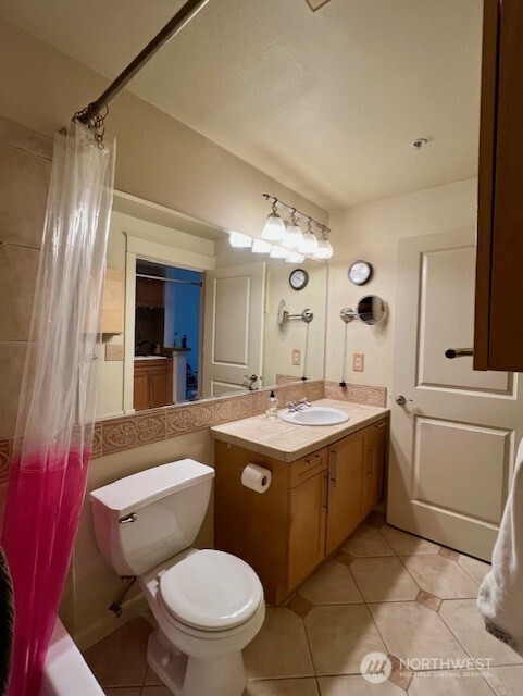 326 Queen Anne Ave N Unit 502, Seattle, WA 98109 - bathroom featuring tile patterned floors, vanity, and toilet
