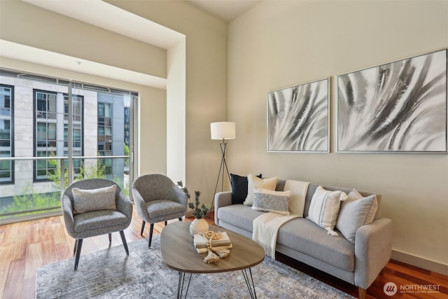 living area featuring baseboards and wood finished floors