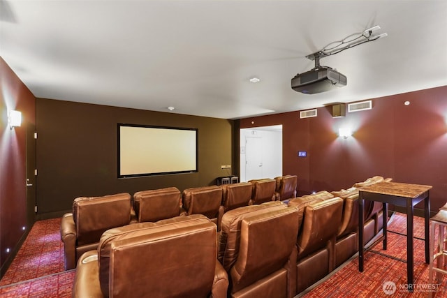 carpeted home theater featuring baseboards and visible vents