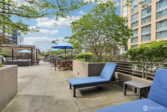 view of patio / terrace with a hot tub