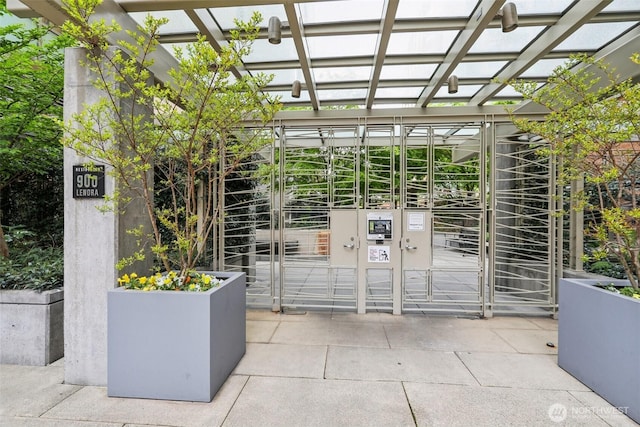 property entrance with a pergola