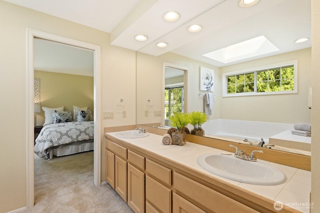 2003 Mill Pointe Dr SE, Mill Creek, WA 98012 - ensuite bathroom with a skylight, recessed lighting, double vanity, and a bathtub