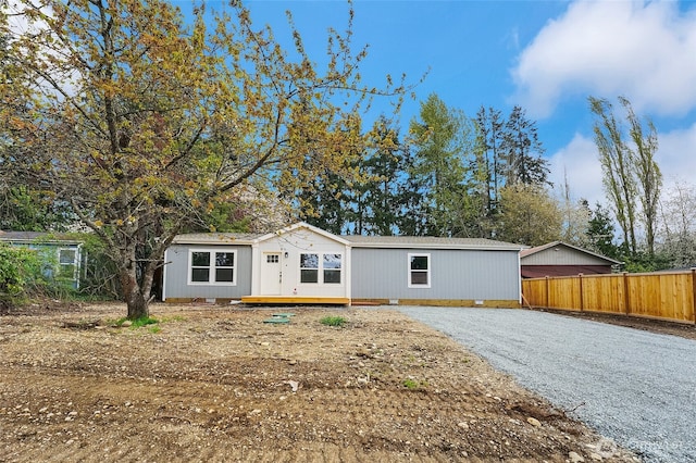 13105 Ridge Cir E, Bonney Lake, WA 98391 - manufactured / mobile home featuring gravel driveway and fence