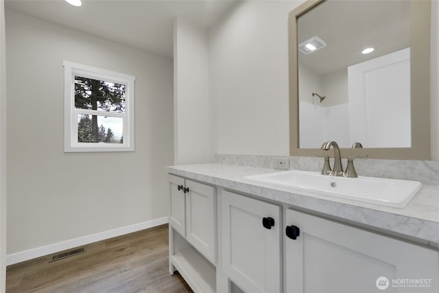 13105 Ridge Cir E, Bonney Lake, WA 98391 - bathroom featuring baseboards, walk in shower, visible vents, vanity, and wood finished floors