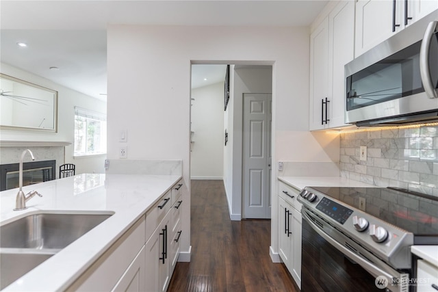 kitchen featuring white cabinetry, tasteful backsplash, stainless steel appliances, dark wood-style floors, and recessed lighting
