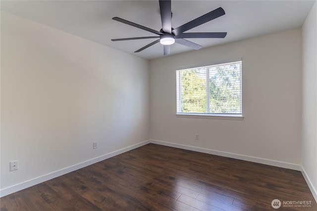 spare room with dark wood-style floors, a ceiling fan, and baseboards
