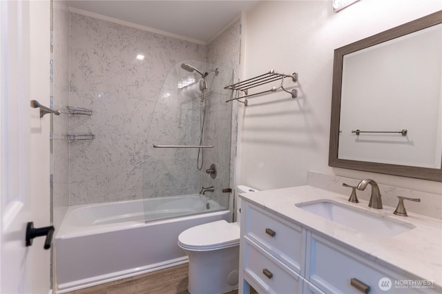 bathroom with wood finished floors, toilet, vanity, and bathing tub / shower combination