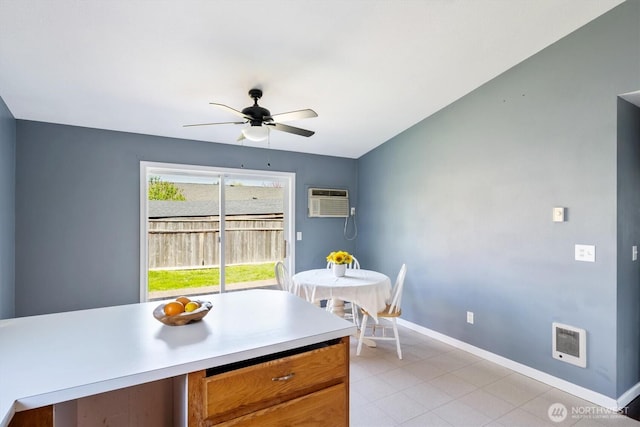 dining space with light tile patterned floors, baseboards, an AC wall unit, a ceiling fan, and heating unit