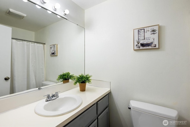 full bathroom with toilet and vanity