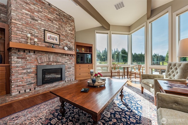 6250 Woodcock Rd, Sequim, WA 98382 - living area featuring wood finished floors and a brick fireplace