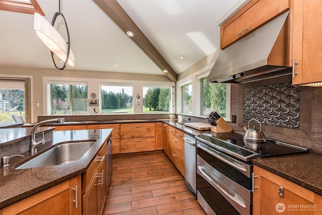 6250 Woodcock Rd, Sequim, WA 98382 - kitchen featuring ventilation hood, range with two ovens, healthy amount of natural light, dark stone counters, and beamed ceiling