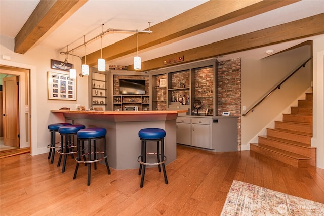 6250 Woodcock Rd, Sequim, WA 98382 - indoor wet bar with beamed ceiling, wood finished floors, stairway, and decorative light fixtures