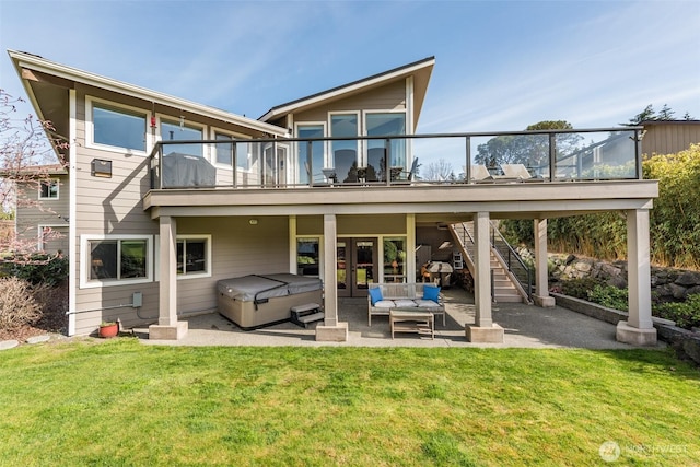 6250 Woodcock Rd, Sequim, WA 98382 - back of property featuring a hot tub, a patio area, a lawn, and stairs