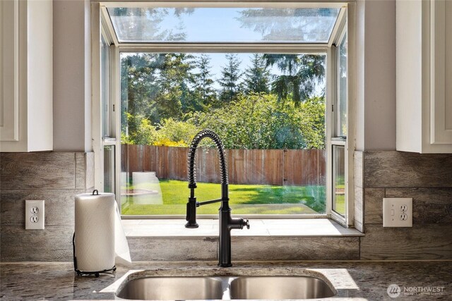 24214 38th Avenue Ct E, Spanaway, WA 98387 - kitchen view of a sink, white cabinetry, and stone counters