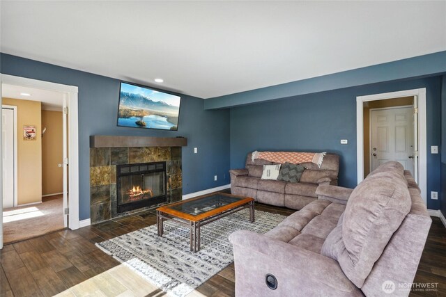 24214 38th Avenue Ct E, Spanaway, WA 98387 - living area with dark wood-style flooring, a tiled fireplace, baseboards, and recessed lighting
