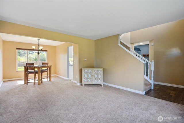 24214 38th Avenue Ct E, Spanaway, WA 98387 - carpeted living area featuring a chandelier, baseboards, and stairway
