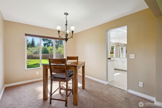 24214 38th Avenue Ct E, Spanaway, WA 98387 - dining area featuring a chandelier, light colored carpet, and healthy amount of natural light