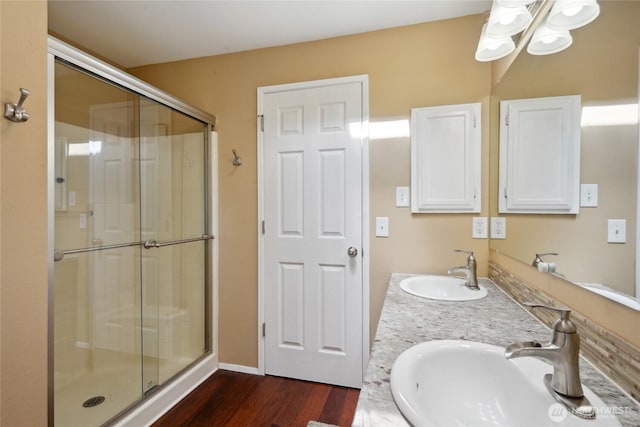 24214 38th Avenue Ct E, Spanaway, WA 98387 - bathroom featuring wood finished floors, a stall shower, and double vanity