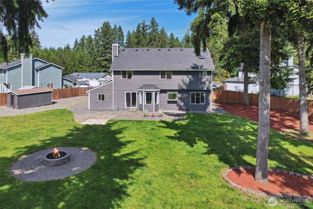 24214 38th Avenue Ct E, Spanaway, WA 98387 - back of house featuring an outdoor fire pit, a chimney, and a patio area