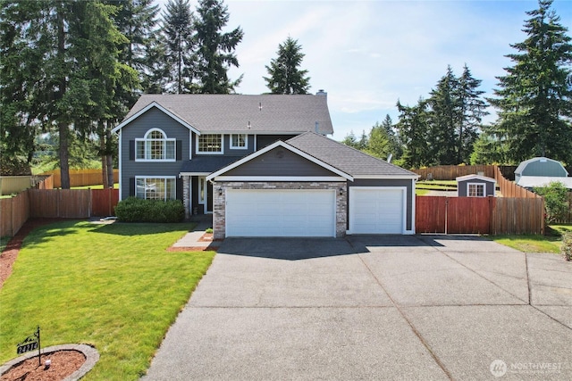 24214 38th Avenue Ct E, Spanaway, WA 98387 - traditional-style house featuring asphalt driveway, a garage, and a shingled roof
