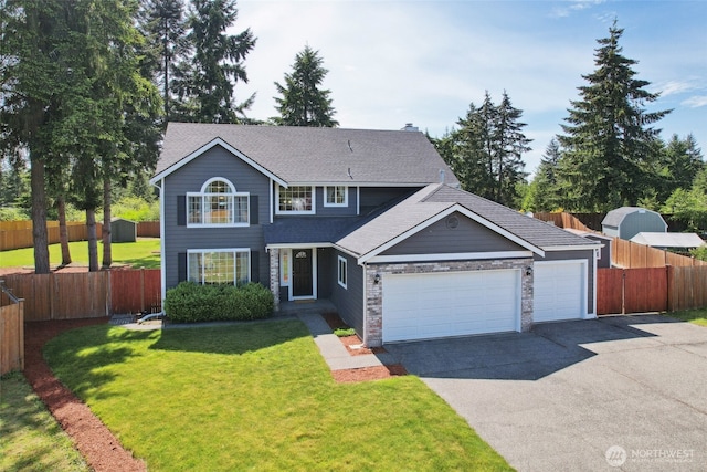 24214 38th Avenue Ct E, Spanaway, WA 98387 - traditional home with driveway, a garage, roof with shingles, and stone siding
