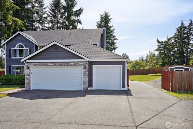 24214 38th Avenue Ct E, Spanaway, WA 98387 - view of front of property featuring asphalt driveway, an attached garage, and a shingled roof